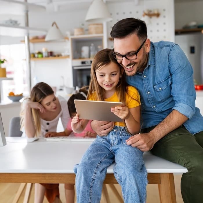 Online school, technology, family concept. Happy young parents helping to children to study at home