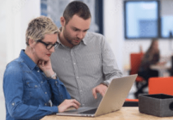 Man and woman looking at a laptop